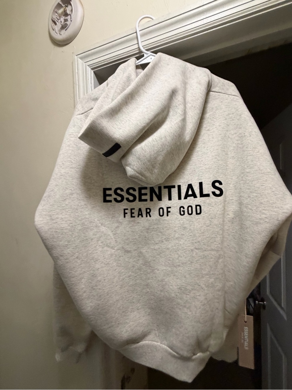 Fear of God Essentials Hoodie in Heather Cream with Black Logo